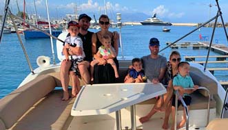 Happy family aboard a flybridge yacht in Antibes