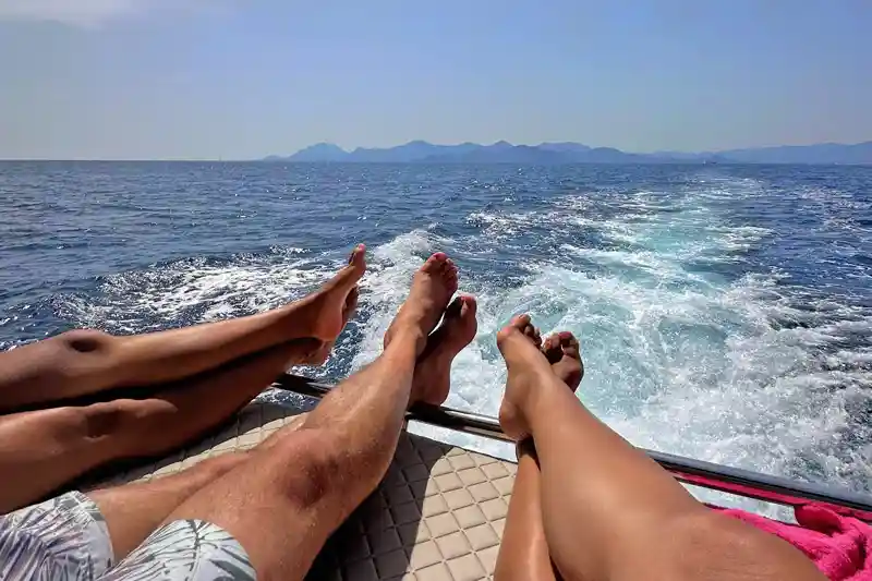Happy family relaxing aboard a yacht rental near Monaco.