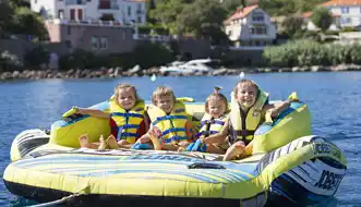 Happy kids on towed water toys